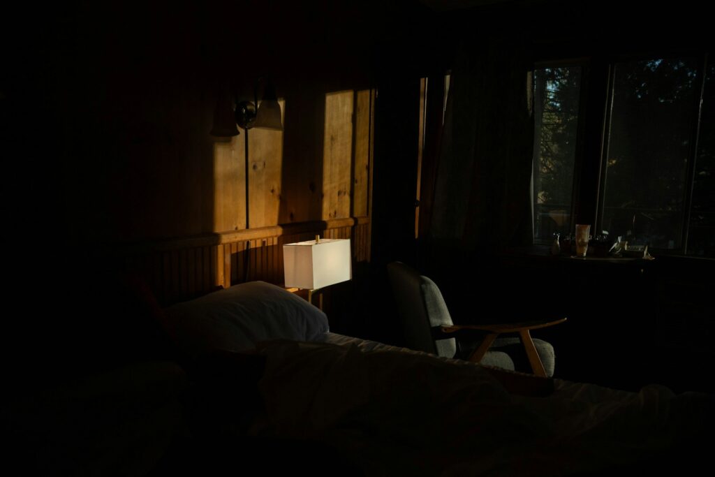 Ochtendlicht dat door het raam op een opgemaakt bed valt